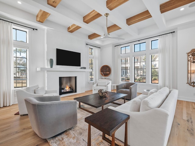 living room with coffered ceiling, beam ceiling, and light hardwood / wood-style flooring