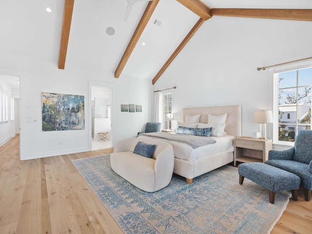 bedroom with multiple windows, hardwood / wood-style floors, and high vaulted ceiling