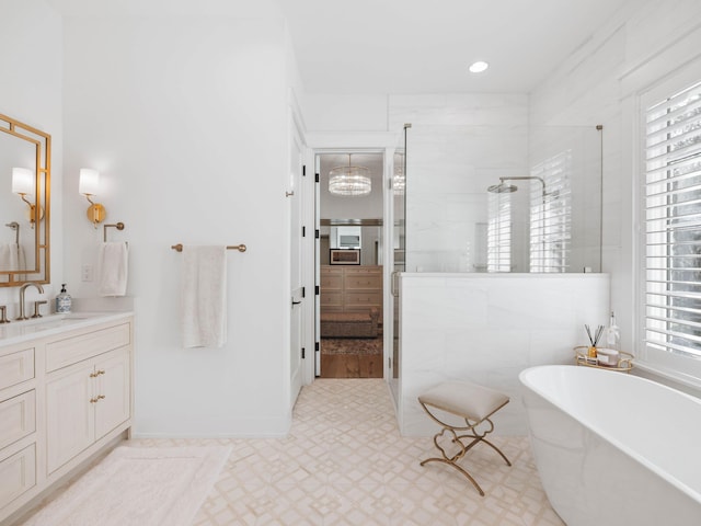 bathroom featuring shower with separate bathtub and vanity