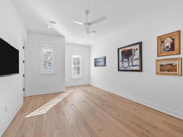 unfurnished living room featuring ceiling fan and light hardwood / wood-style floors