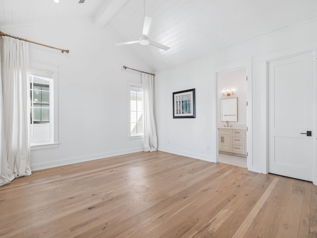 interior space featuring vaulted ceiling with beams, ceiling fan, sink, and light wood-type flooring