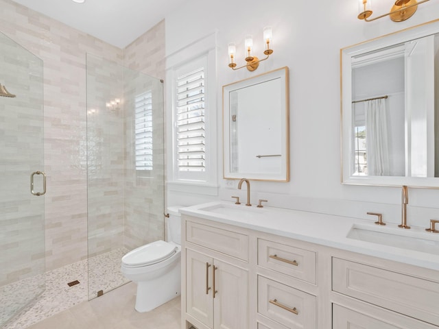 bathroom with tile patterned flooring, vanity, an enclosed shower, and toilet