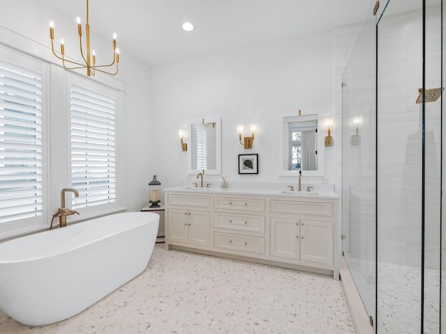 bathroom with vanity, a notable chandelier, and separate shower and tub