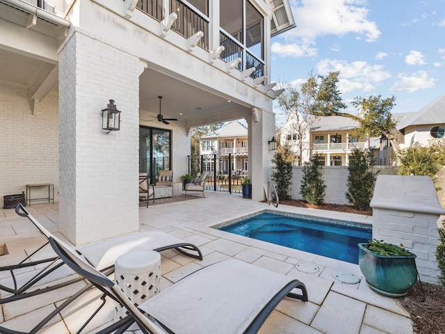 view of pool with a patio and ceiling fan