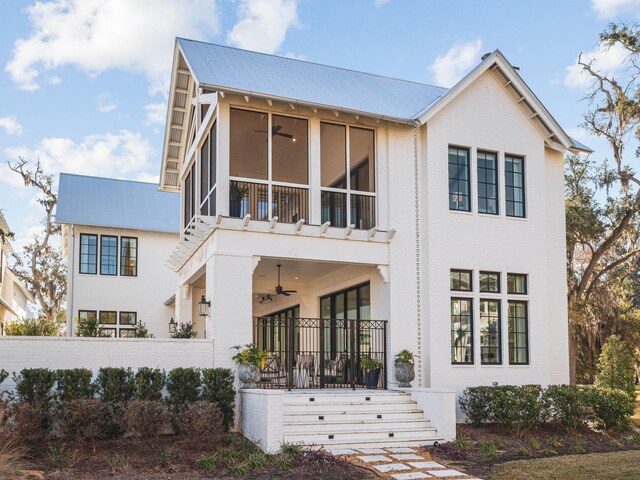 view of front of home with ceiling fan, a balcony, and a sunroom