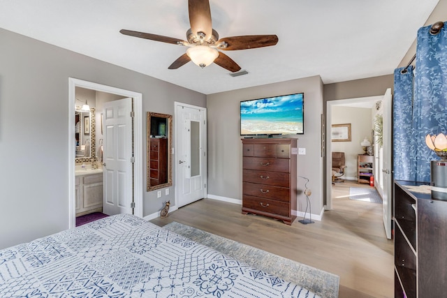 bedroom featuring light hardwood / wood-style flooring, ceiling fan, and ensuite bathroom