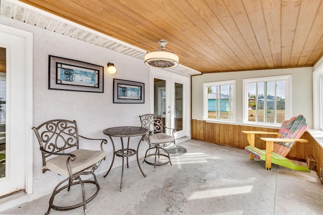 sunroom / solarium featuring wooden ceiling and french doors