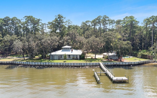 view of dock featuring a water view and a yard