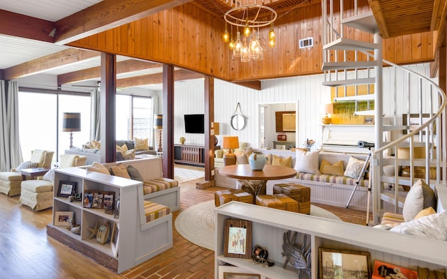 living room featuring beam ceiling and a chandelier