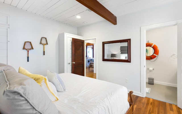 bedroom with beamed ceiling, wooden ceiling, and dark hardwood / wood-style flooring