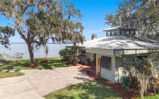 view of front facade with a water view and a front yard