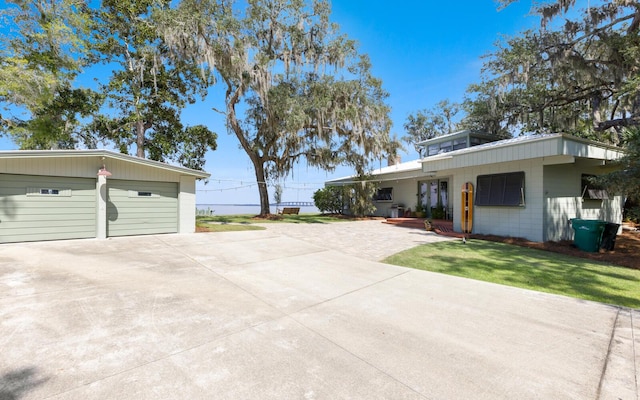 view of home's exterior with a garage and a lawn