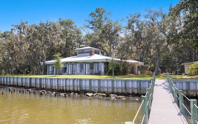 dock area with a yard and a water view