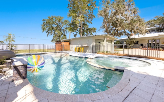 view of pool featuring an in ground hot tub and a patio