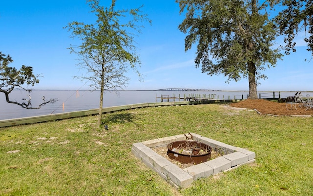 view of yard with a water view and an outdoor fire pit