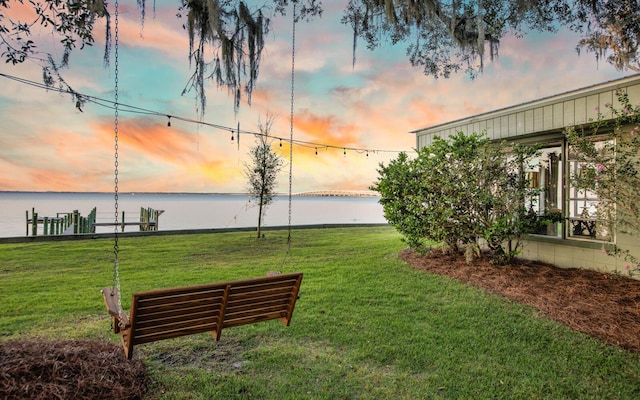 view of property's community featuring a water view and a yard