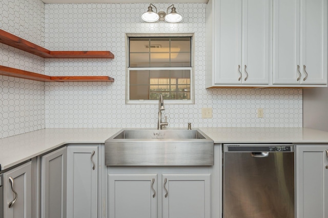 kitchen with white cabinets, dishwasher, sink, and backsplash