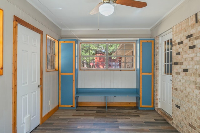 foyer entrance featuring ornamental molding, brick wall, ceiling fan, and dark hardwood / wood-style flooring