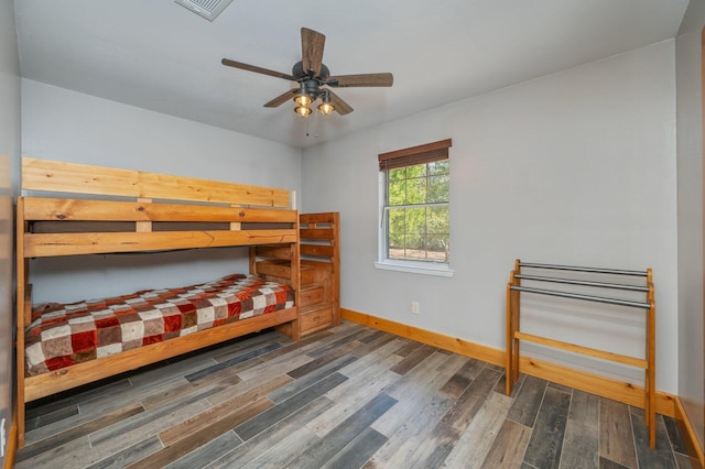 bedroom with dark wood-type flooring and ceiling fan