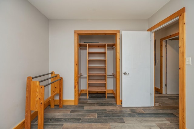 unfurnished bedroom with dark hardwood / wood-style flooring and a closet