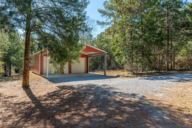 exterior space featuring an outbuilding, a carport, and a garage