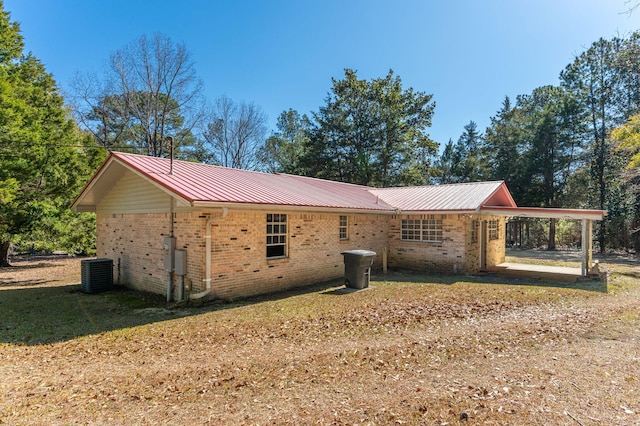 view of side of home with a carport and central AC unit