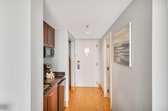 interior space featuring dark stone countertops and light hardwood / wood-style floors