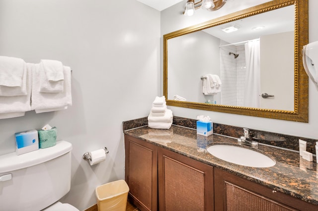 bathroom featuring vanity, a shower with shower curtain, and toilet