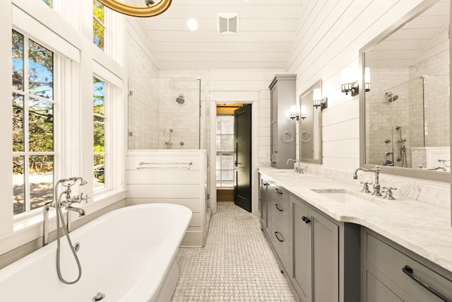 bathroom featuring vanity, plus walk in shower, tile patterned flooring, and vaulted ceiling