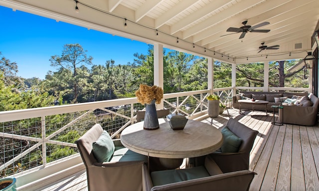 wooden terrace with an outdoor hangout area and ceiling fan