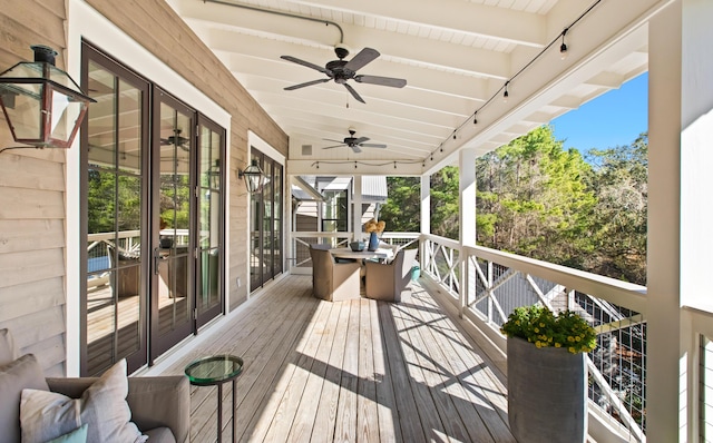 wooden terrace featuring ceiling fan