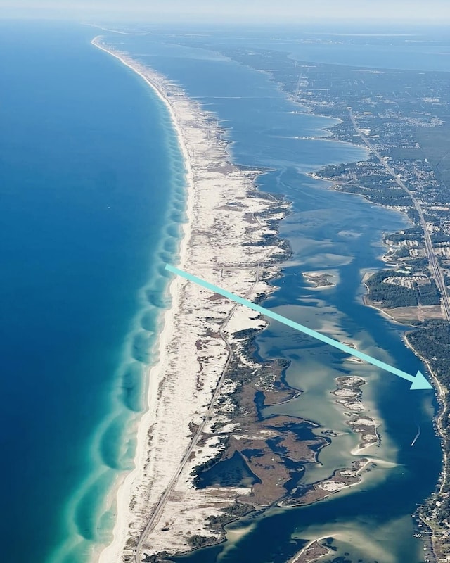 bird's eye view featuring a water view and a beach view