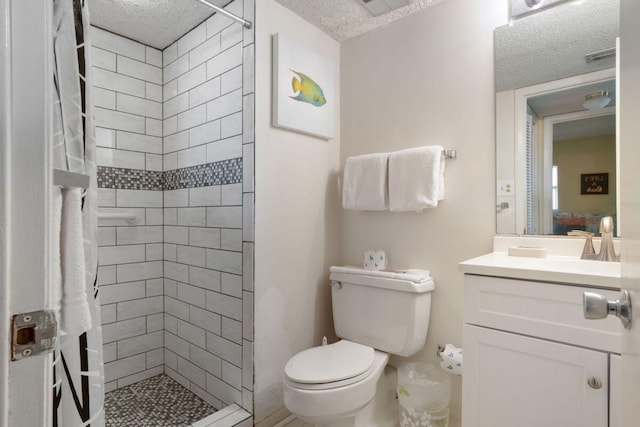 909 Santa Rosa Blvd Unit 329, Fort Walton Beach, FL 32548 - bathroom featuring vanity, a textured ceiling, toilet, and a tile shower