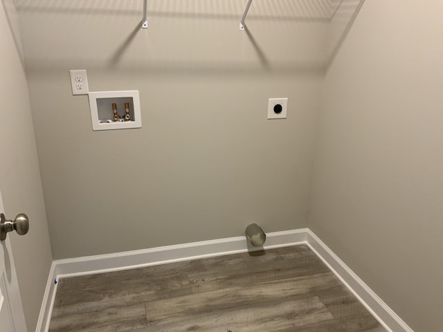 laundry area with hookup for a washing machine, hookup for an electric dryer, wood finished floors, laundry area, and baseboards