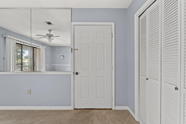 interior space featuring a closet, a textured ceiling, and carpet