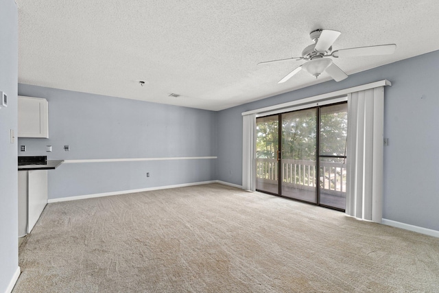 unfurnished living room with a textured ceiling, light colored carpet, and ceiling fan