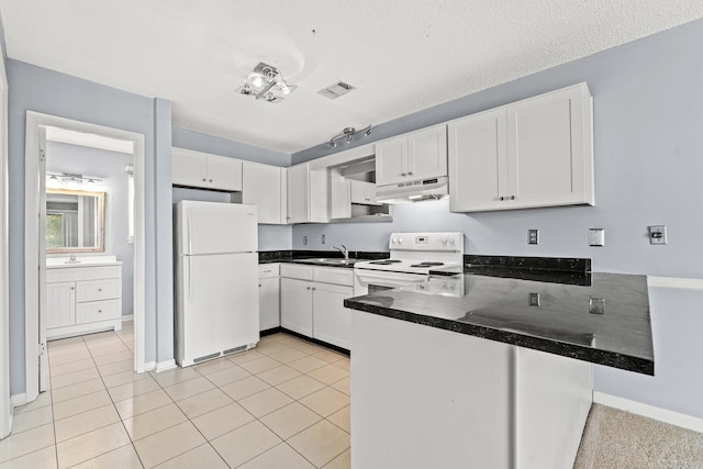 kitchen with sink, light tile patterned floors, kitchen peninsula, white appliances, and white cabinets