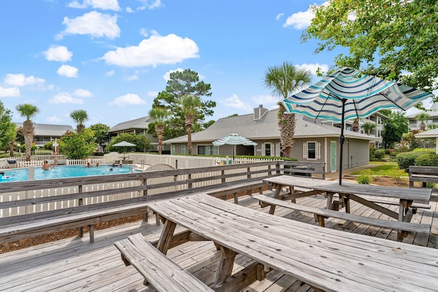 wooden deck with a fenced in pool