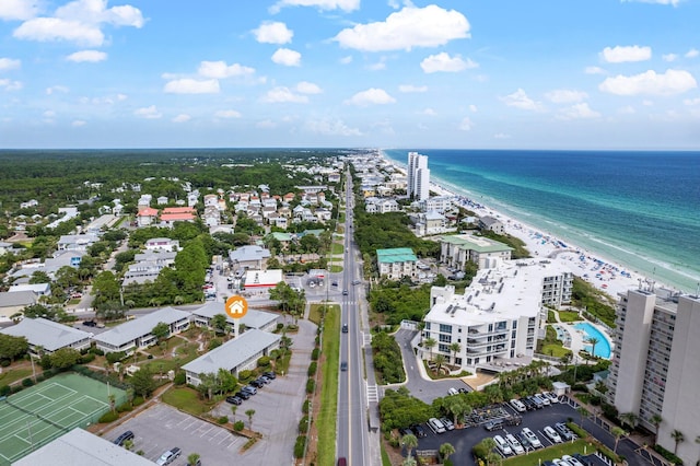 drone / aerial view with a water view and a beach view