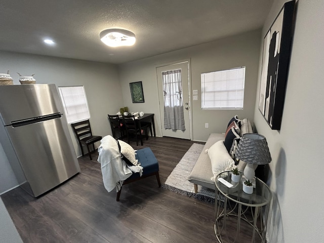living room featuring dark hardwood / wood-style floors and a textured ceiling