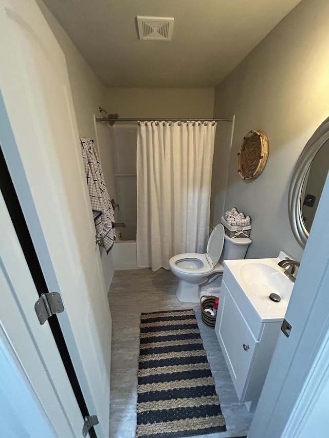 full bathroom featuring shower / bath combo, vanity, and toilet