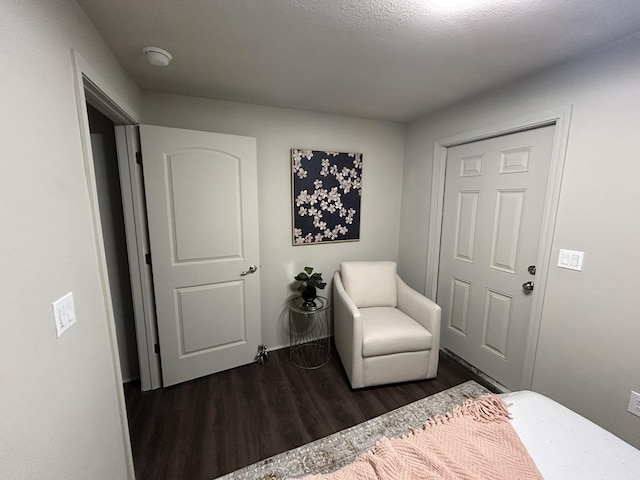 bedroom with dark hardwood / wood-style floors