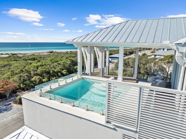 view of pool with a water view