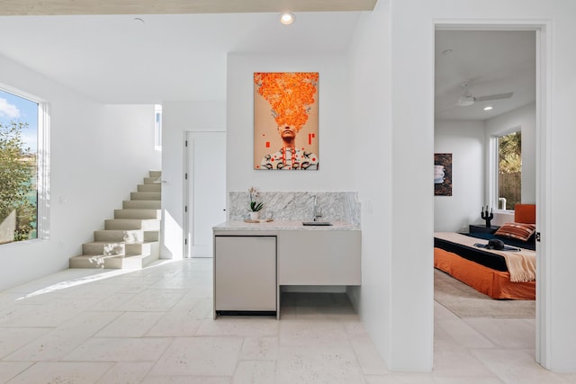 hallway featuring stairway, a wealth of natural light, and recessed lighting