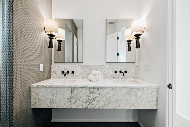 full bathroom with double vanity, visible vents, and a sink