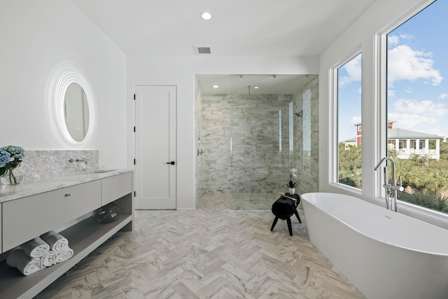 bathroom featuring visible vents, a freestanding bath, vanity, a walk in shower, and recessed lighting