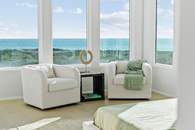 bedroom with a water view and baseboards