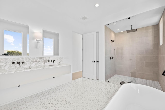 bathroom featuring a freestanding tub, recessed lighting, visible vents, double vanity, and walk in shower