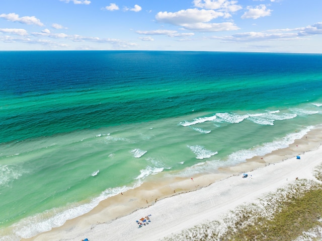 birds eye view of property featuring a water view and a beach view