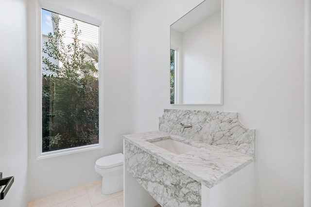 bathroom with tile patterned flooring, vanity, and toilet